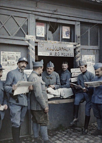 French soldiers buying and reading newspapers at a kiosk in Rexpoede, Department Nord, Region Nord-Pas-de-Calais, France, September 6, 1917 by Paul Castelnau